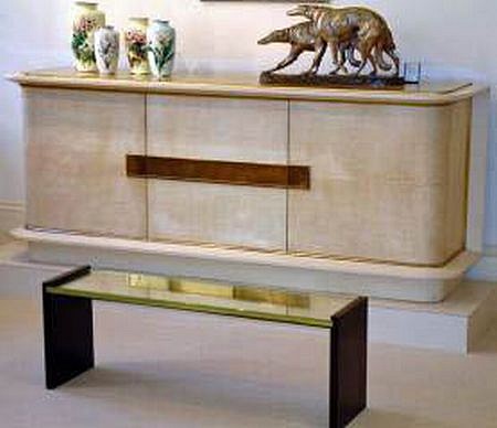 Jacques Adnet,  Cabinet in Original Parchment , c. 1935  parchment colored lacquer and gilded glass top.  Giltz bronze lockplates and fittings.  Interior in Oak and original shelves., 34 x 86 x 20 1/2 inches